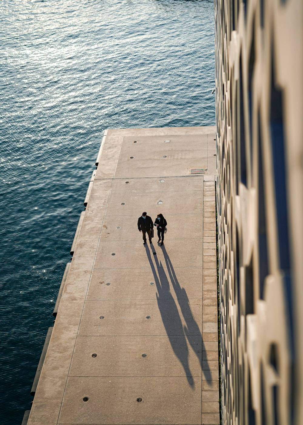 a couple of people that are standing on a dock