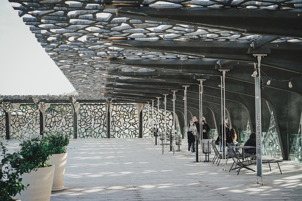 a group of people standing under a covered walkway