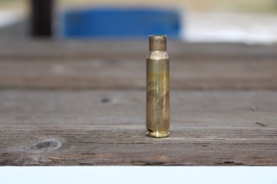a close up of a bullet on a wooden surface