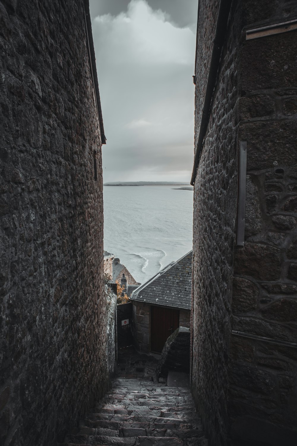 a narrow alley leading to a body of water