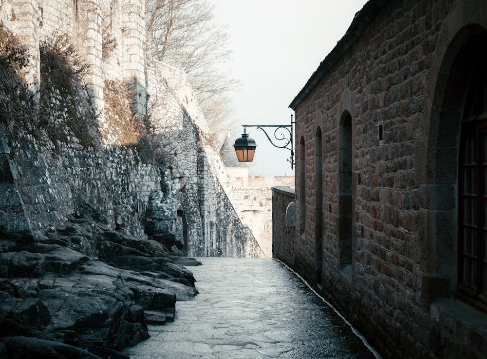 a cobblestone street leading to a stone building