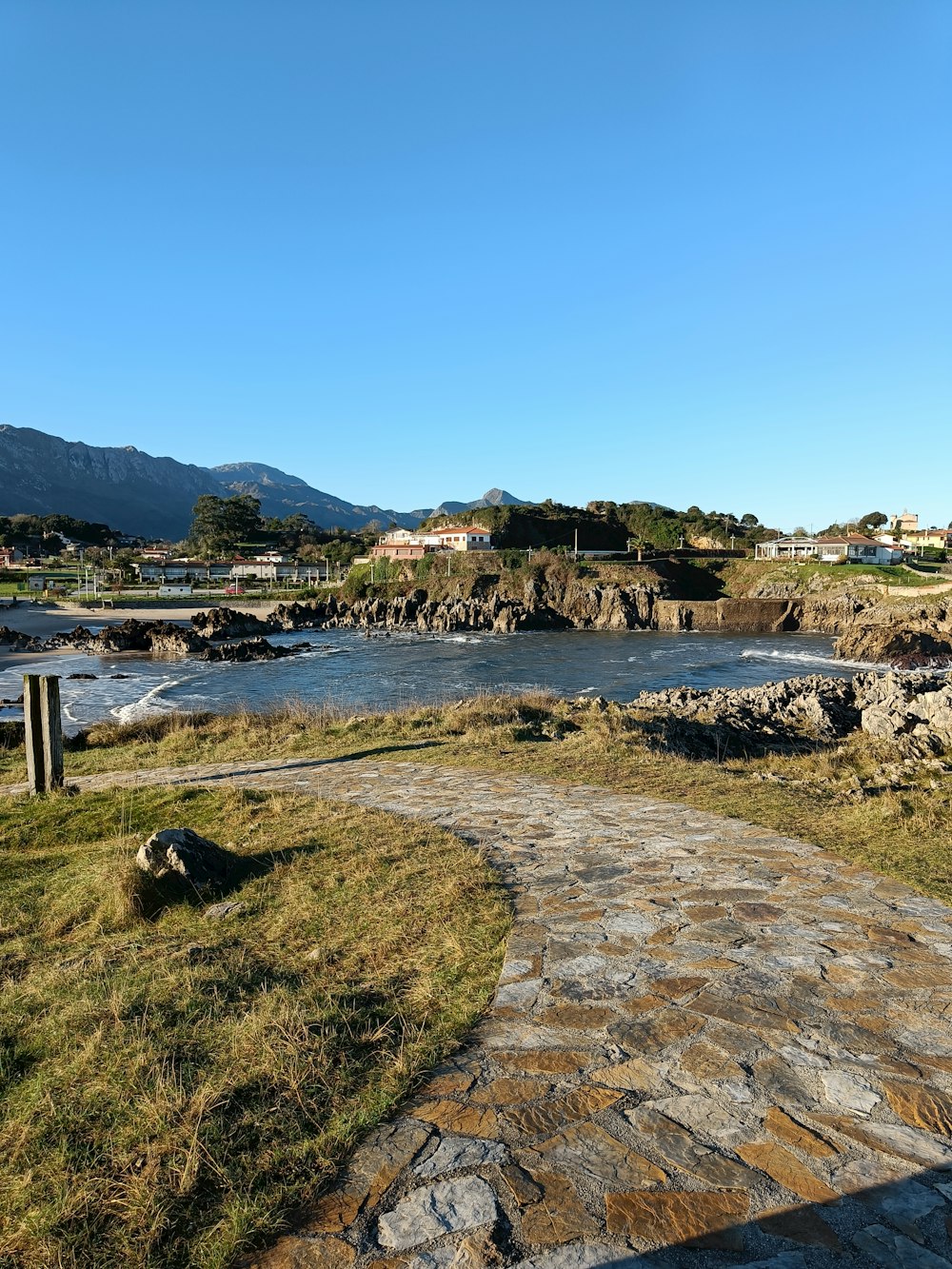 a stone path leading to a body of water