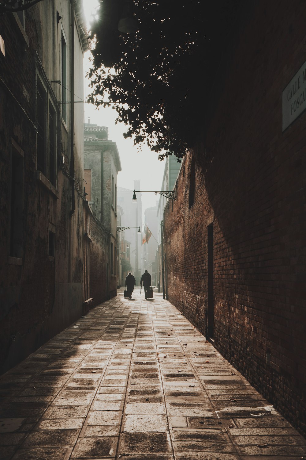 a couple of people walking down a street