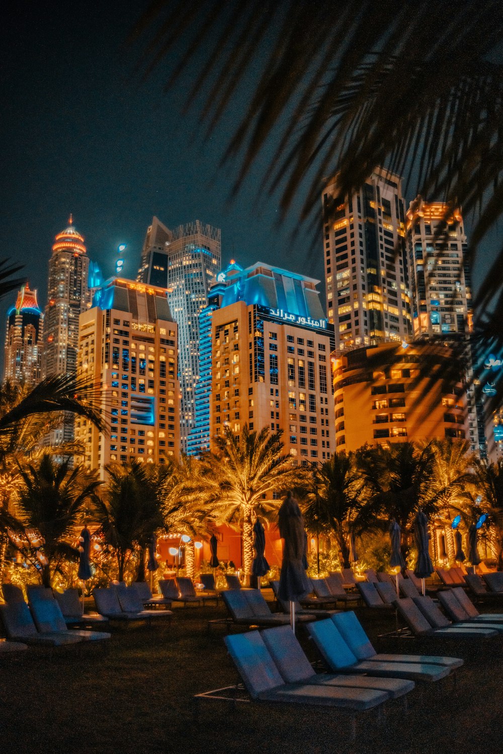 a group of lounge chairs sitting in front of tall buildings