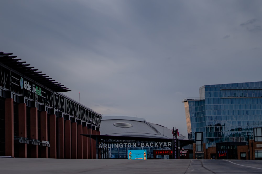 an empty parking lot with a building in the background