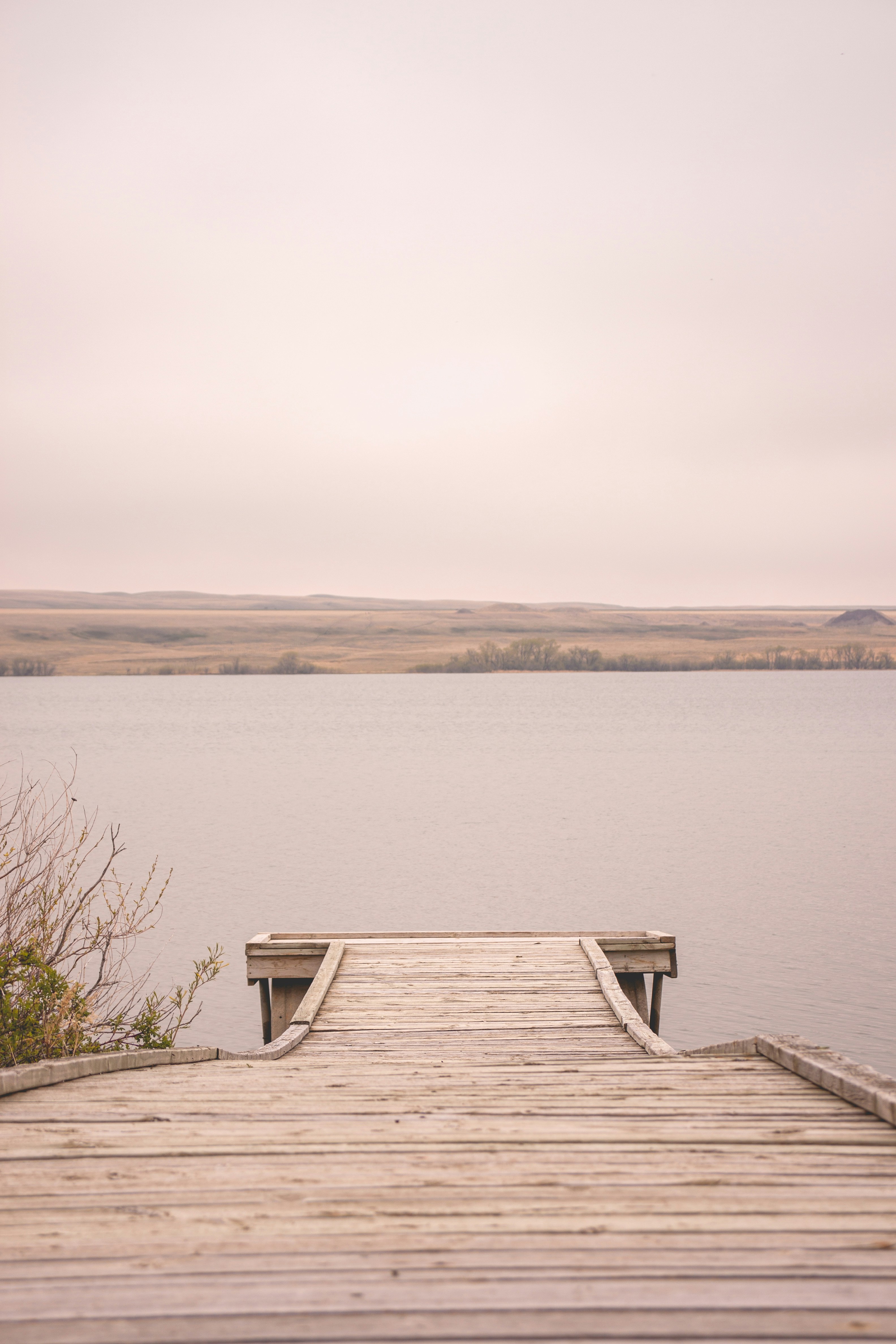 a wooden dock sitting on top of a lake