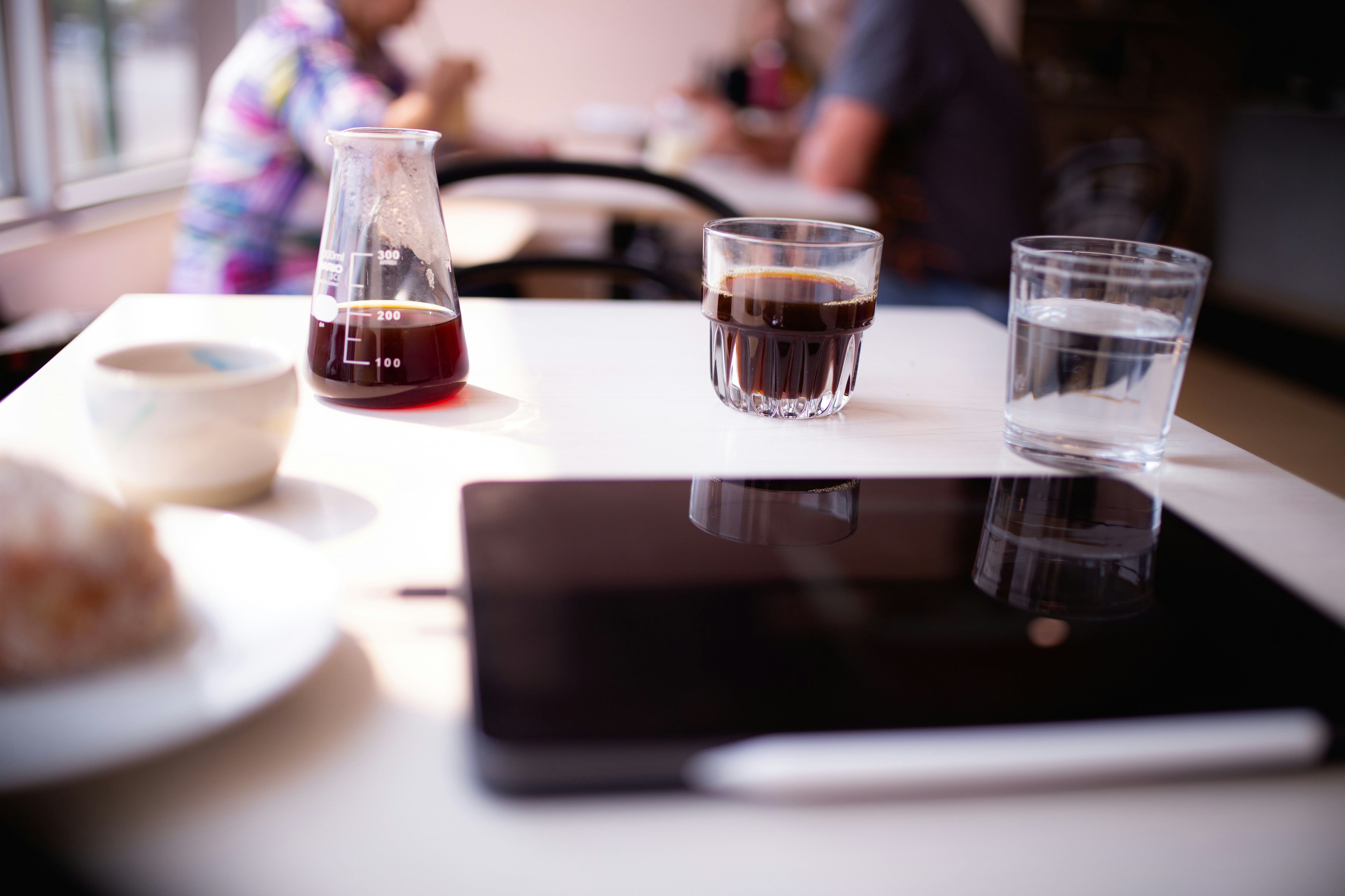 two glasses of liquid are sitting on a table