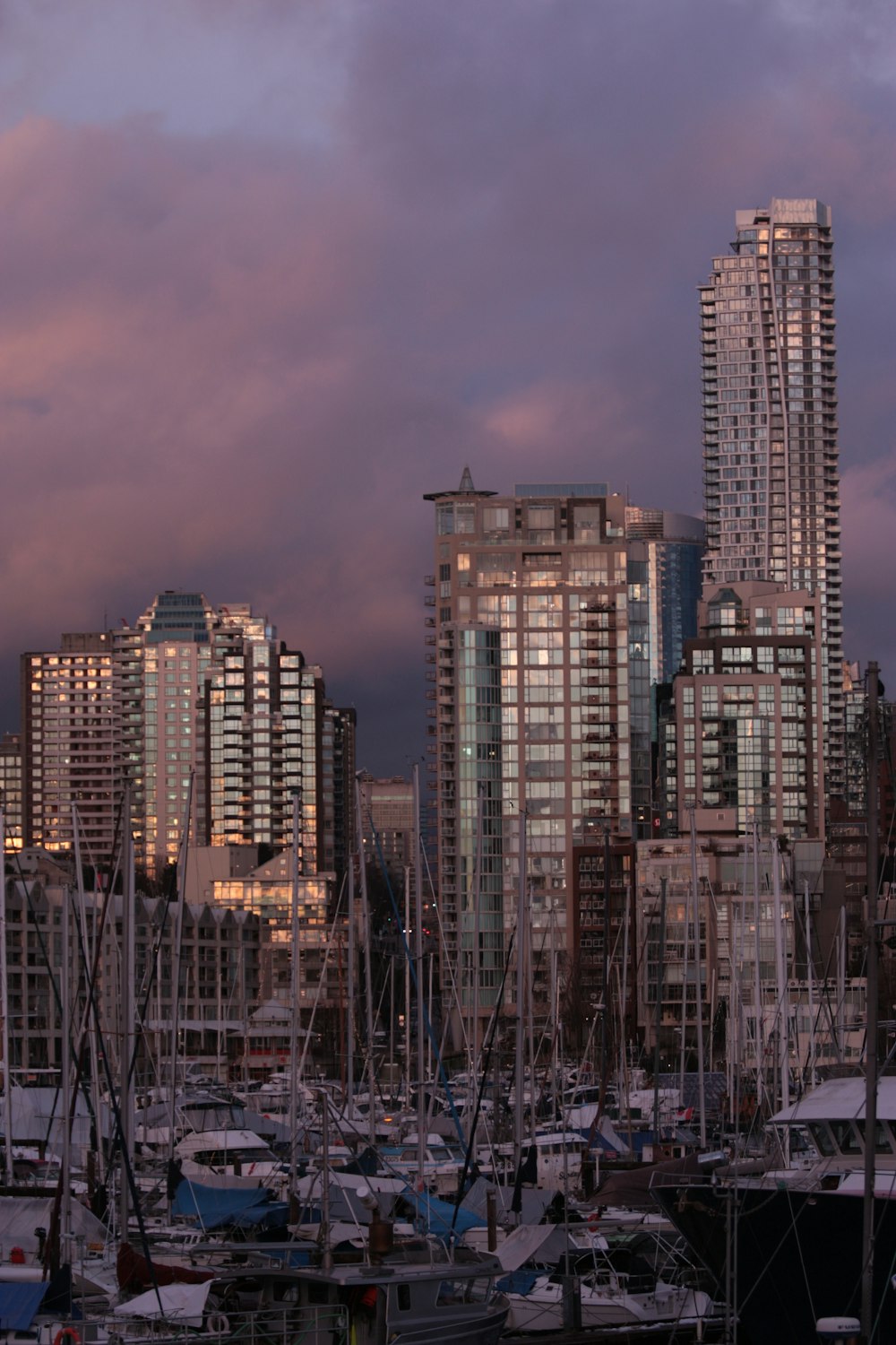 a harbor filled with lots of boats under a cloudy sky