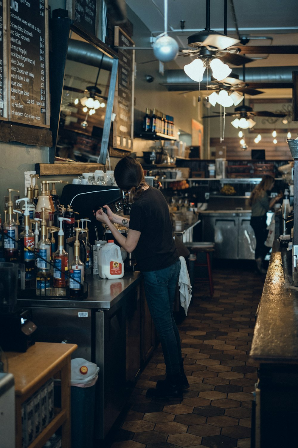 a person standing at a counter in a restaurant