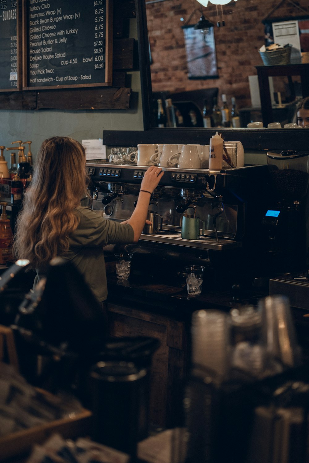 a woman is working at a coffee shop