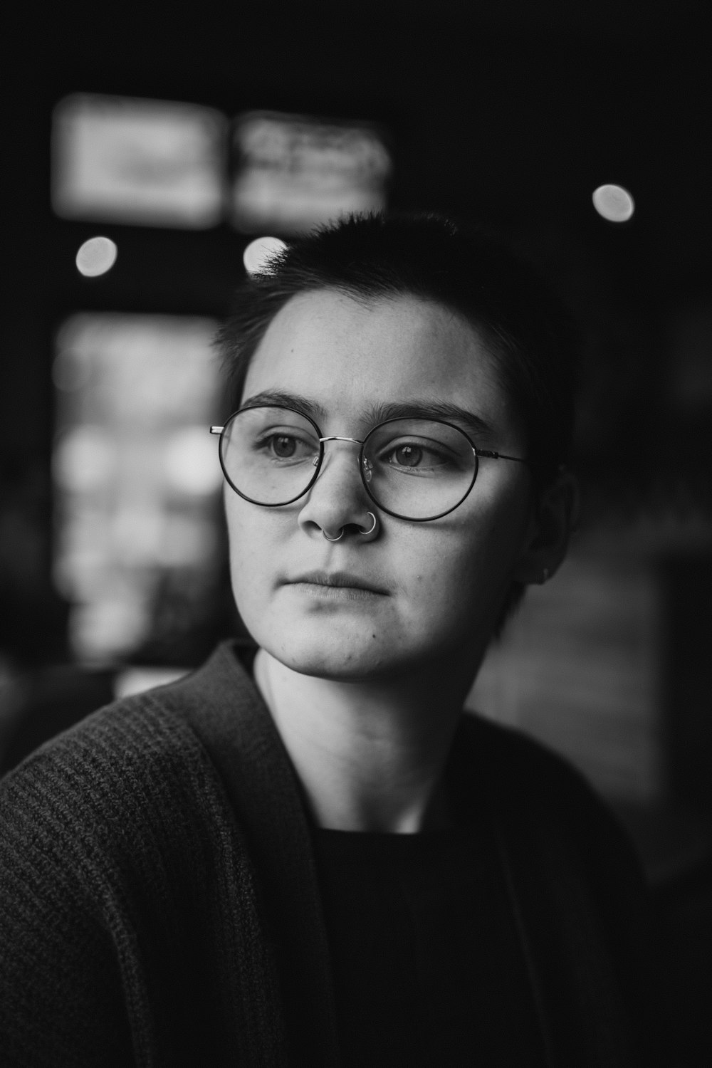 a black and white photo of a woman wearing glasses