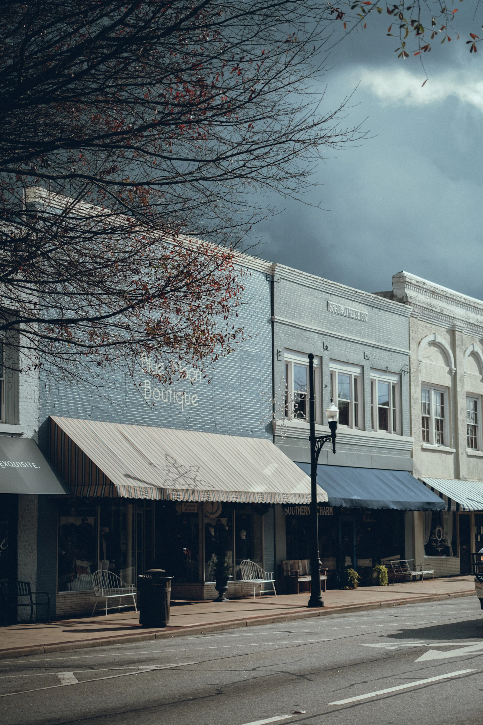 A small-town street with storefronts along it.