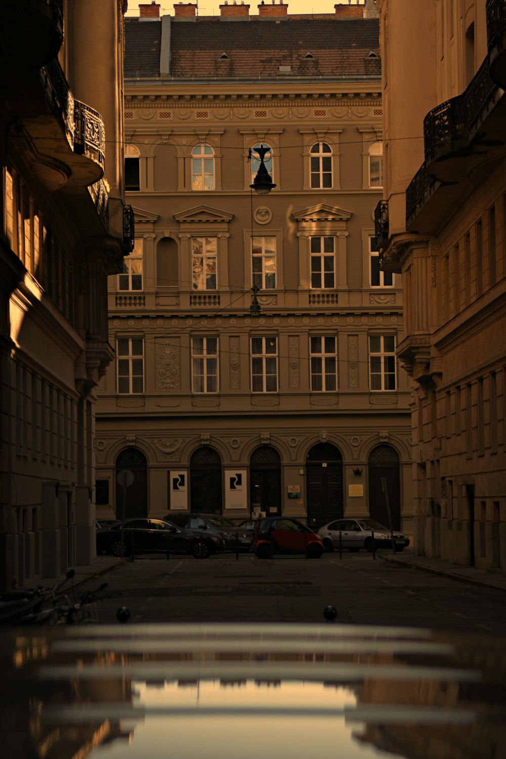 a city street with a reflection of a building