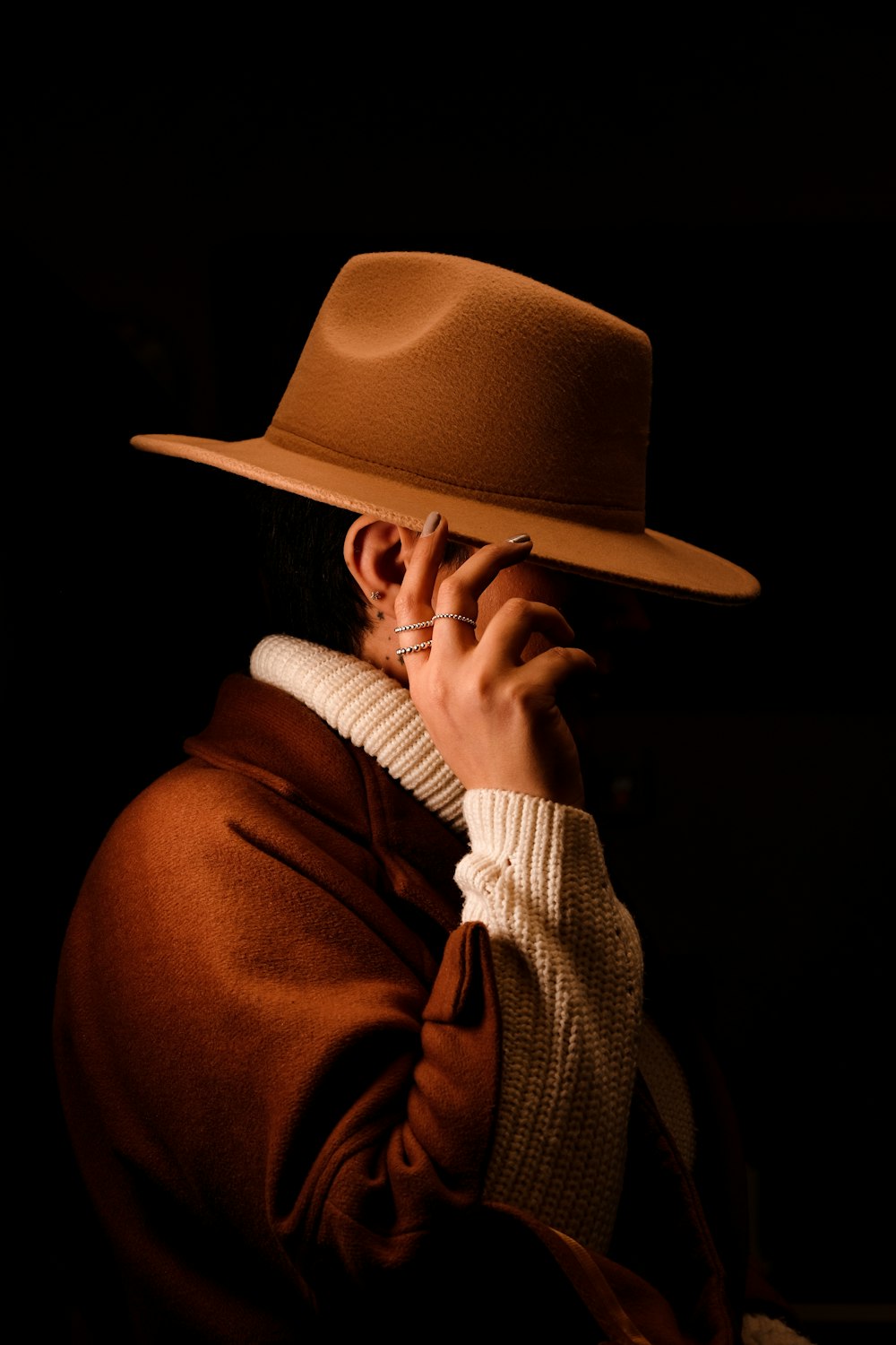 a person wearing a brown hat and coat