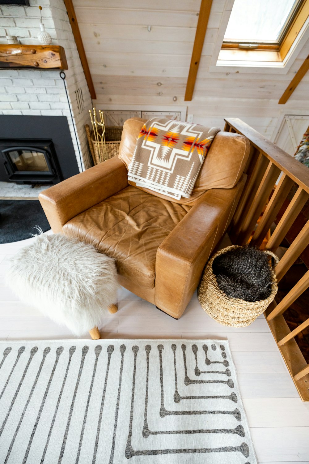 a living room with a chair and a rug