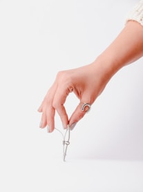 a woman's hand holding a pair of scissors