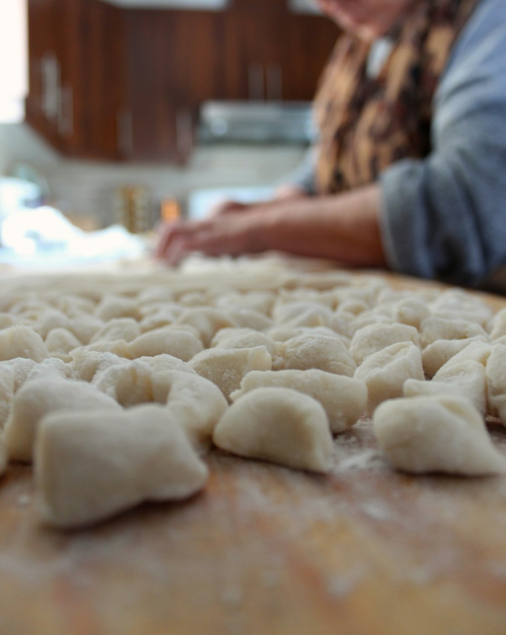 a person is making dumplings on a table