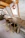 Handcrafted wooden dining table with intricate carvings in a cozy living room