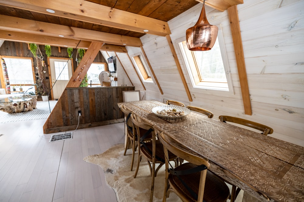 a room with a wooden table and chairs