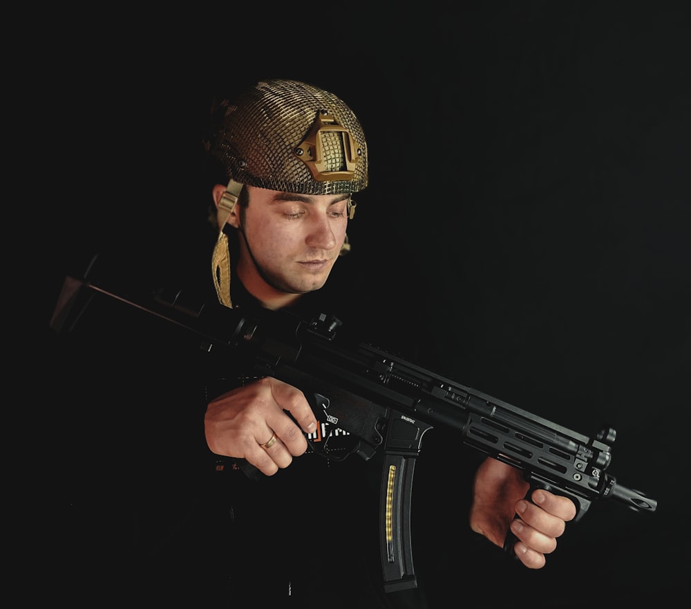 a man in a helmet holding a rifle