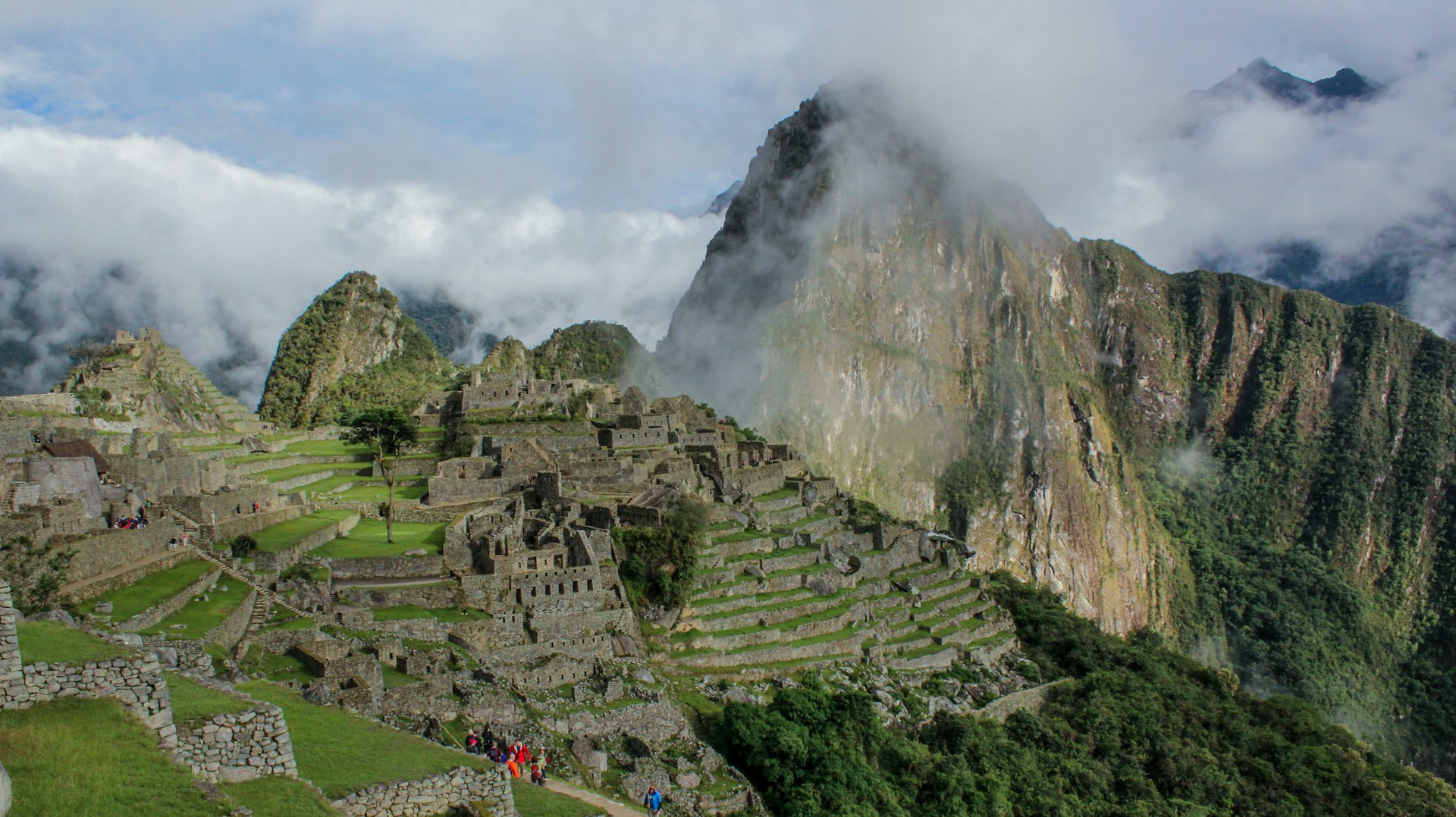 a group of people standing on the side of a mountain