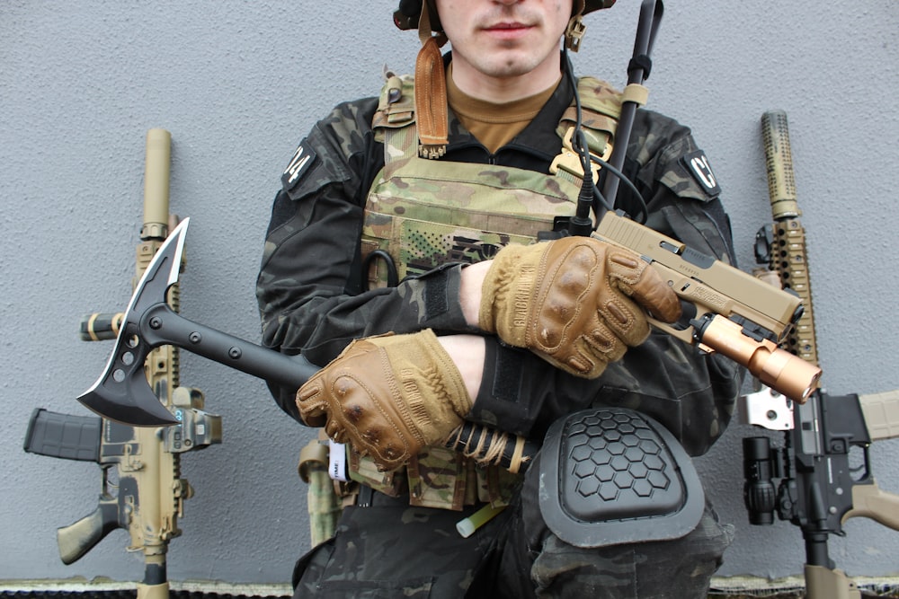 a man in a military uniform holding a gun