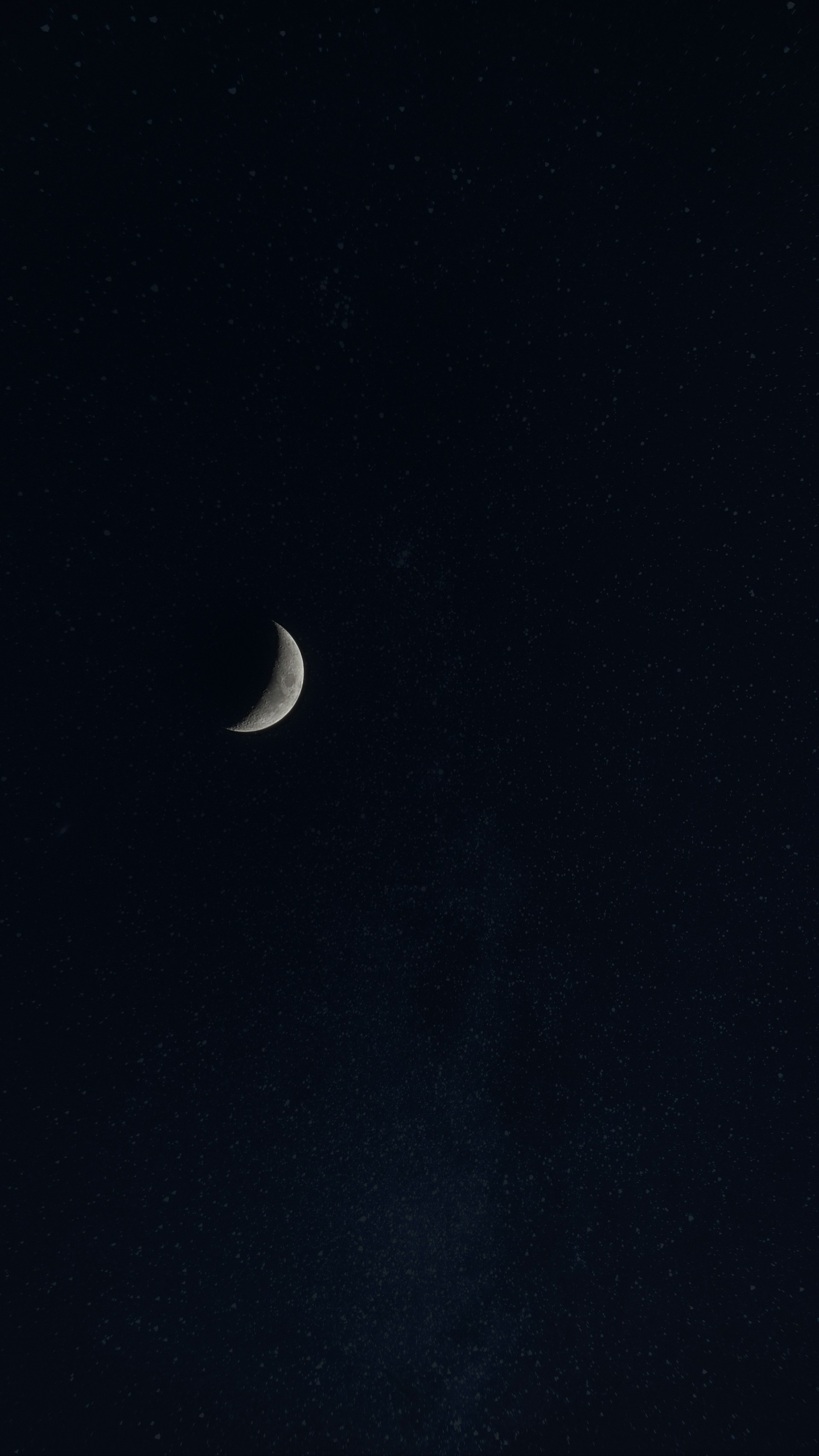 a half moon is seen in the night sky