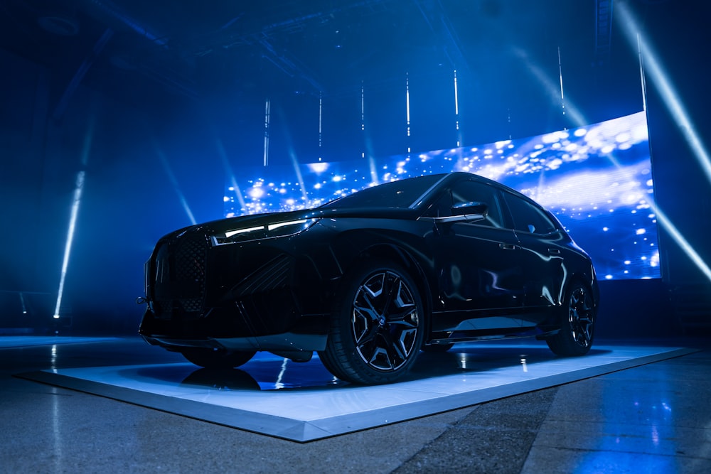 a black car on display at a show