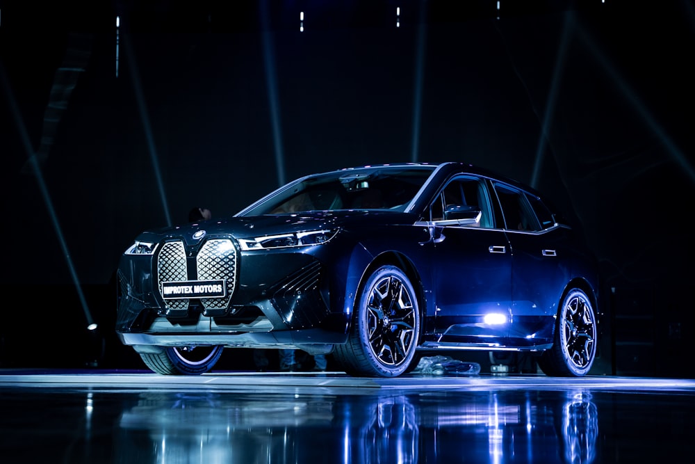 a car on display in a dark room