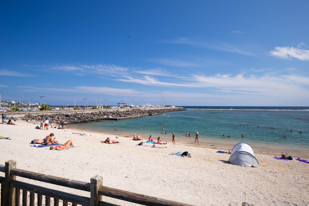 a beach filled with lots of people on top of it