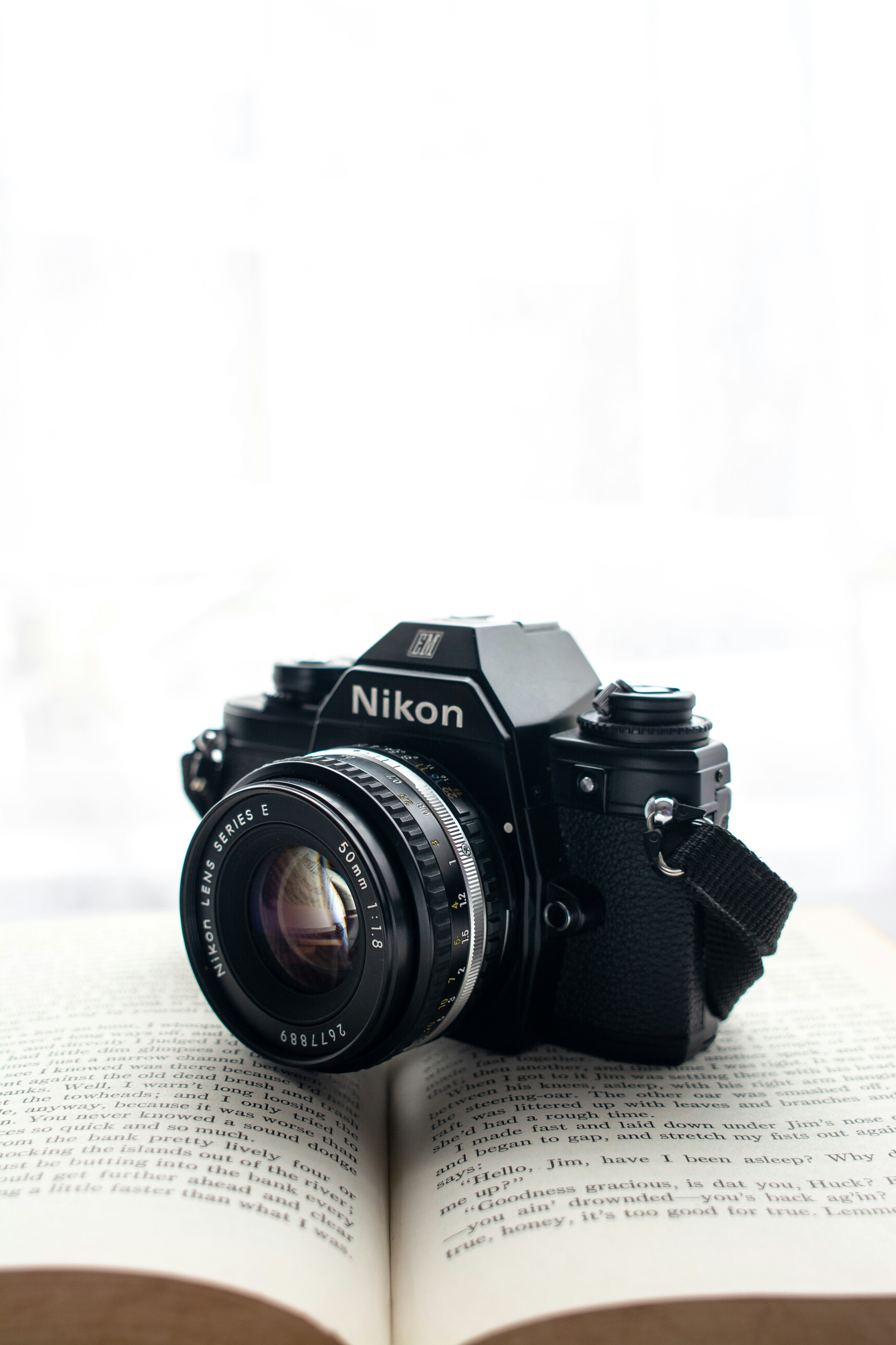 a camera sitting on top of an open book