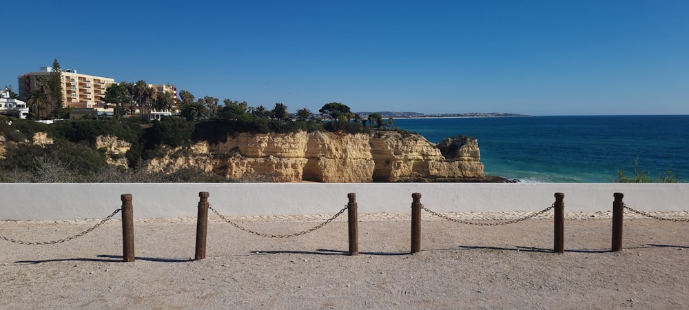 a view of a beach with a cliff in the background