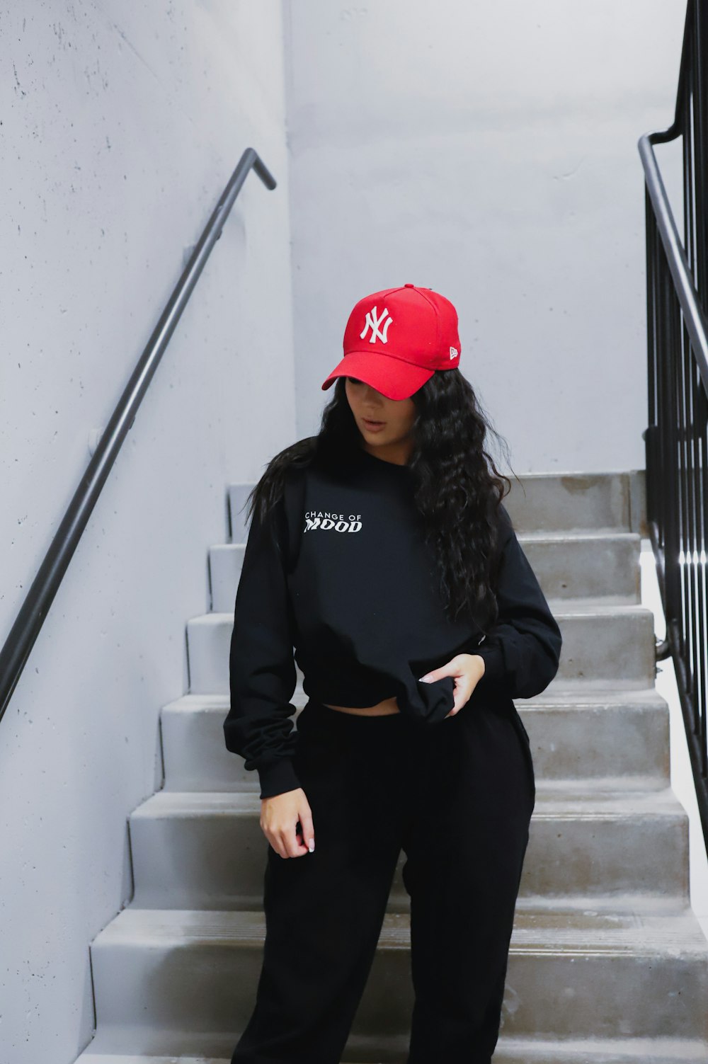 A woman wearing a red hat and black sweat suit photo – Free Canada Image on  Unsplash