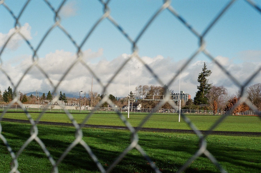 a view of a soccer field through a chain link fence