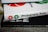 A stack of books with visible spines. The top book is titled 'Photography Rules' with red and green shutter icons, while another book beneath reads 'READ THIS IF YOU WANT TO TAKE GREAT PHOTOGRAPHS.' The surface has a textured fabric appearance.