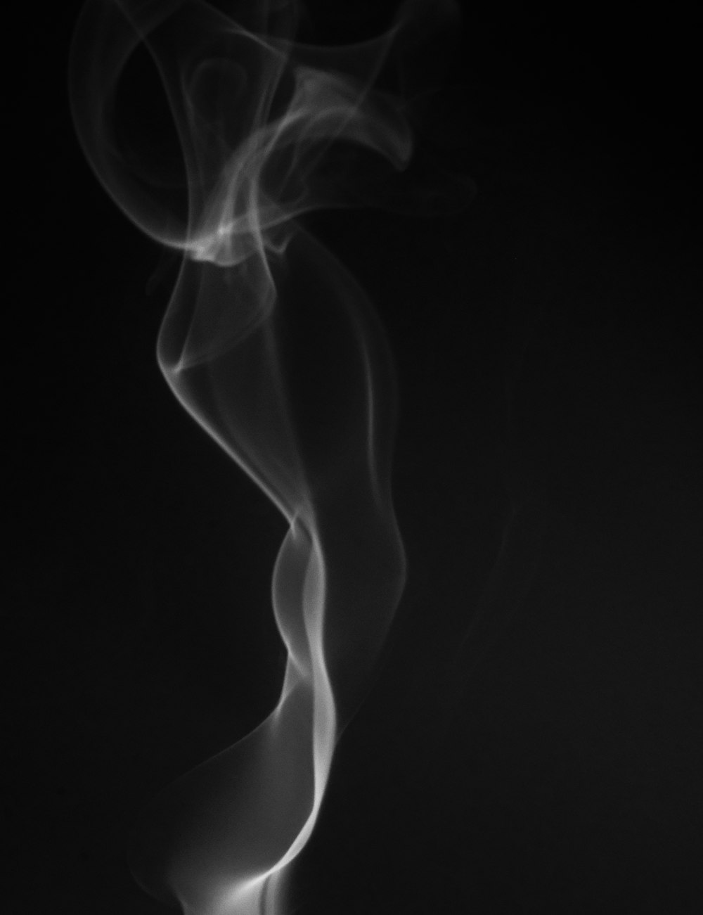 a black and white photo of smoke