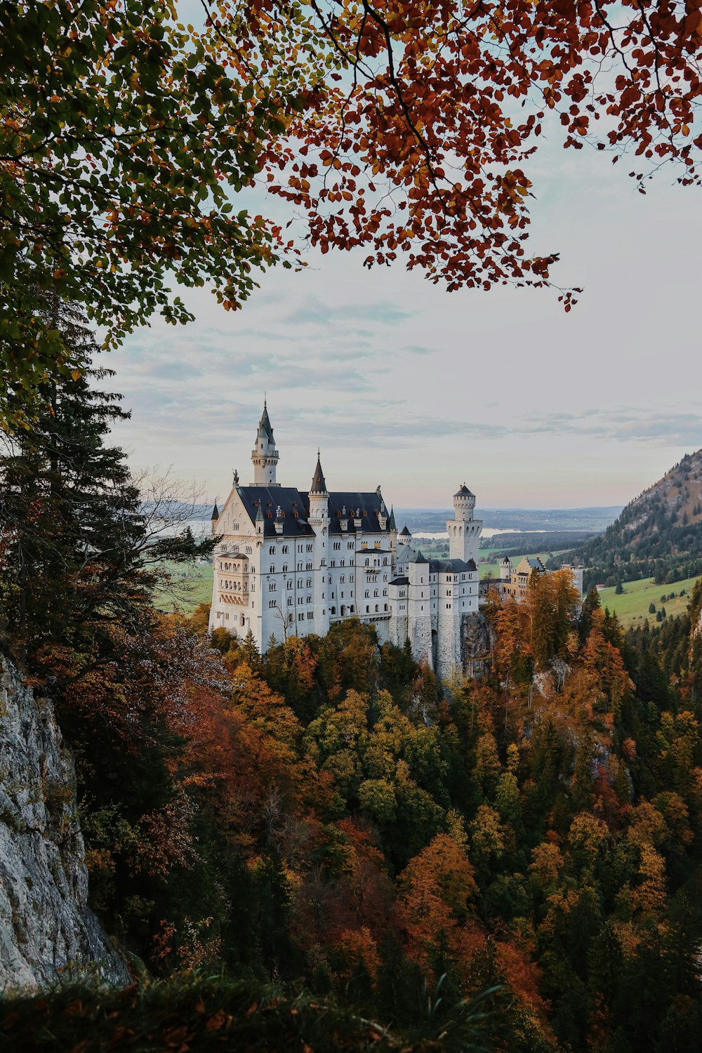 a castle on a hill with Neuschwanstein Castle in the background