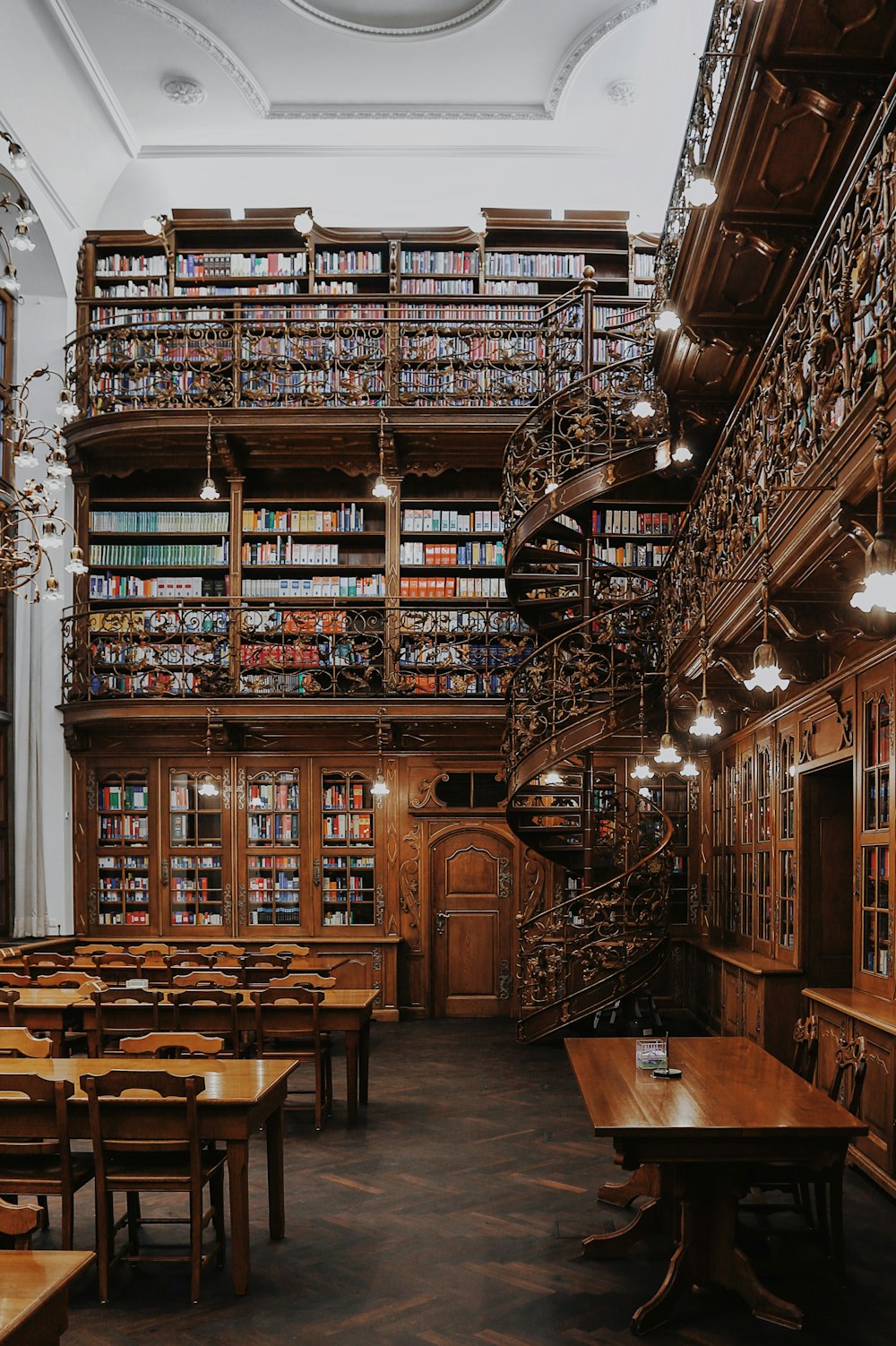 a room filled with furniture and a table in a library