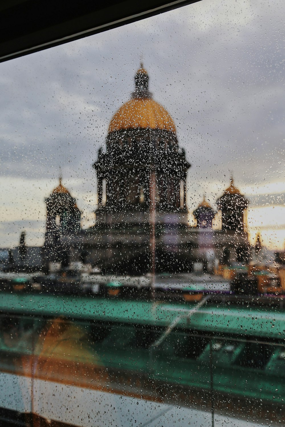 a view of a building through a rainy window