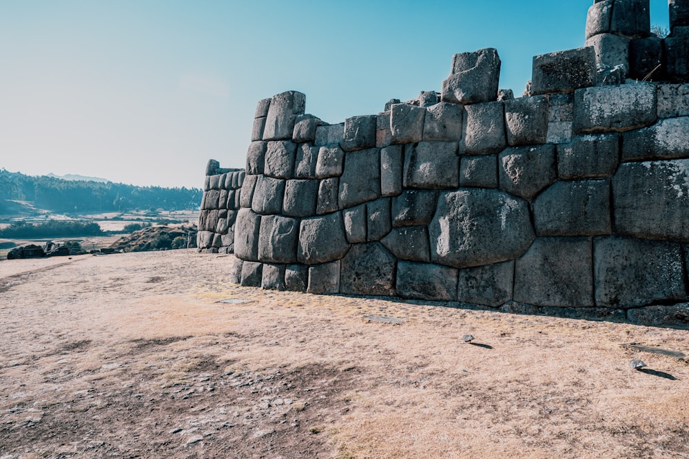 a stone wall made of rocks in the desert