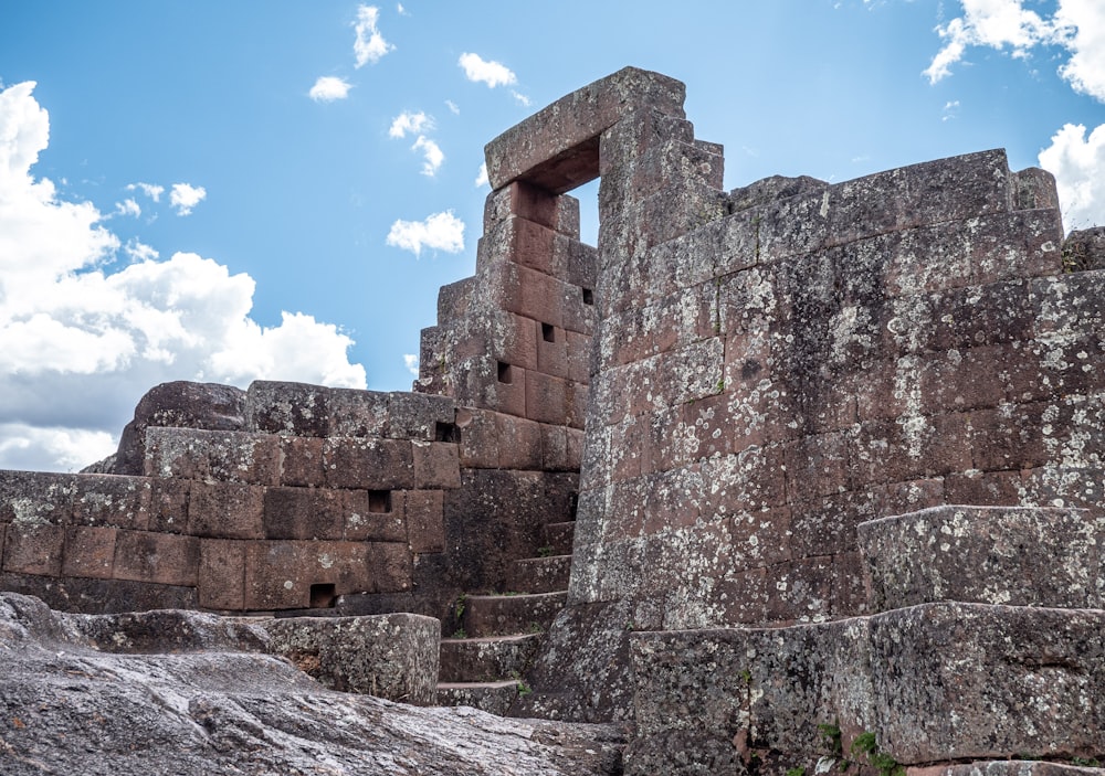 a stone structure with a window in the middle of it