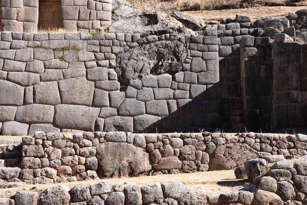 a stone wall with a doorway in the middle of it