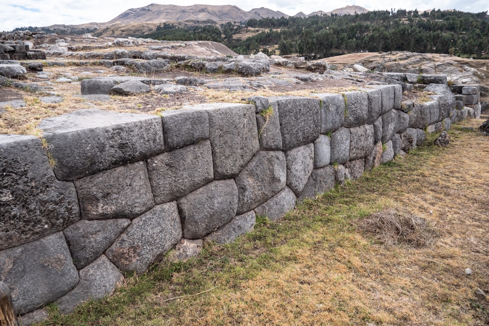 a stone wall in the middle of a field