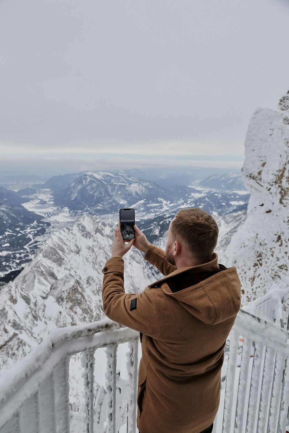 a man standing in front of a mountain