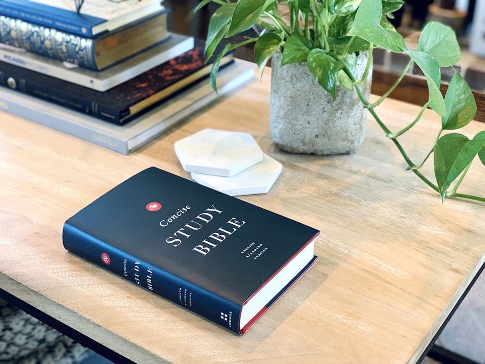 a stack of books sitting on top of a wooden table