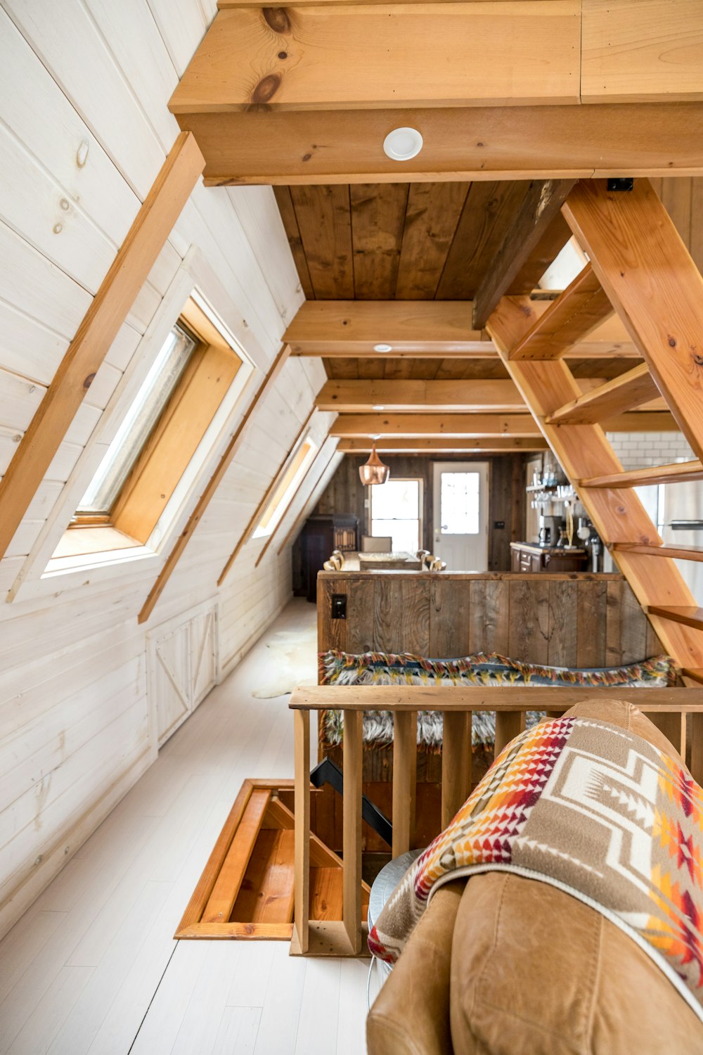 a loft with a loft bed and loft stairs