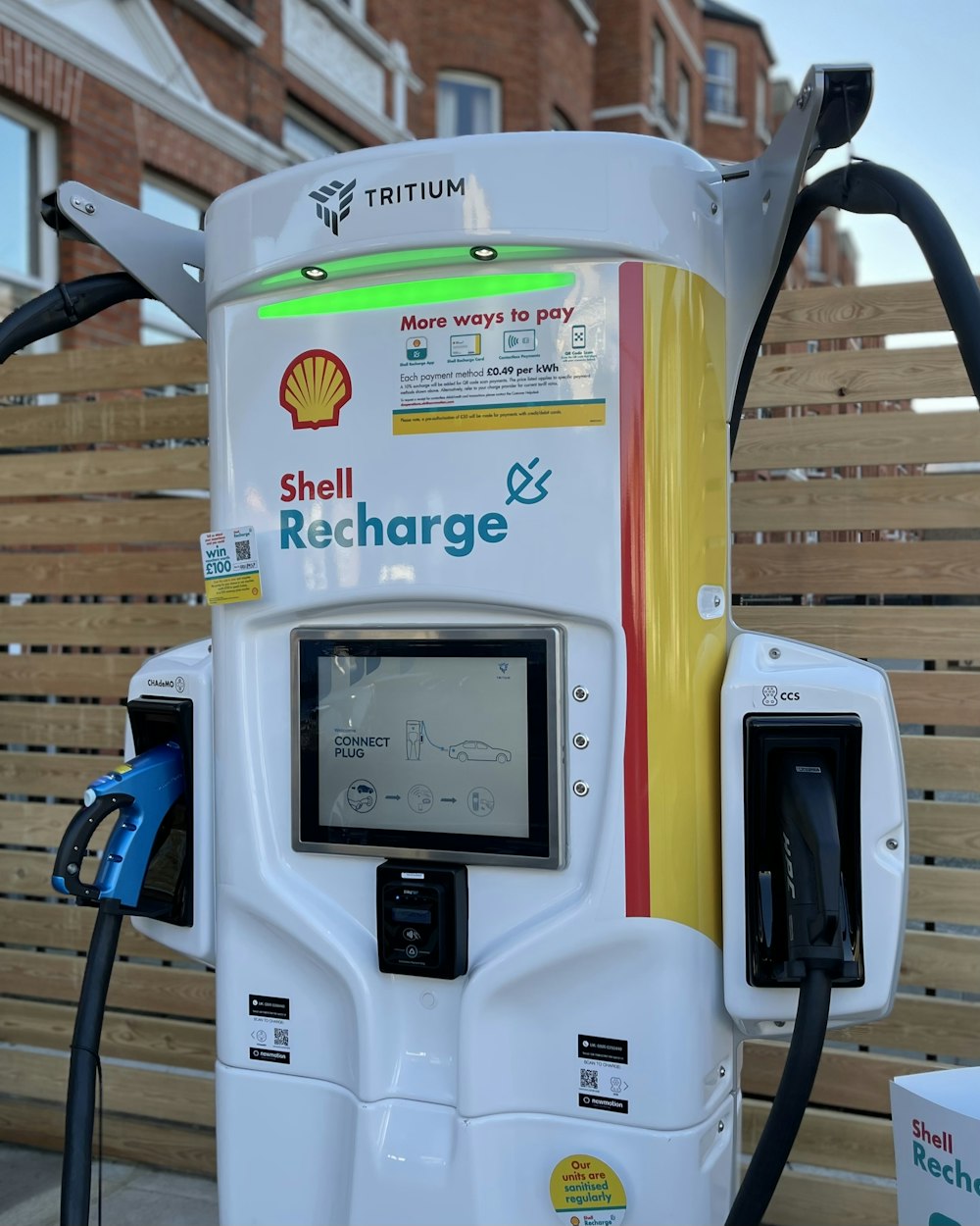 a shell gas pump with a charger attached to it