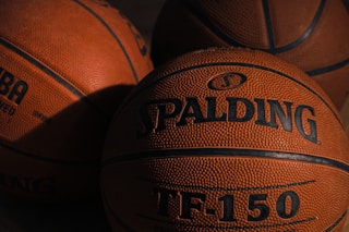 a close up of three basketballs on a table