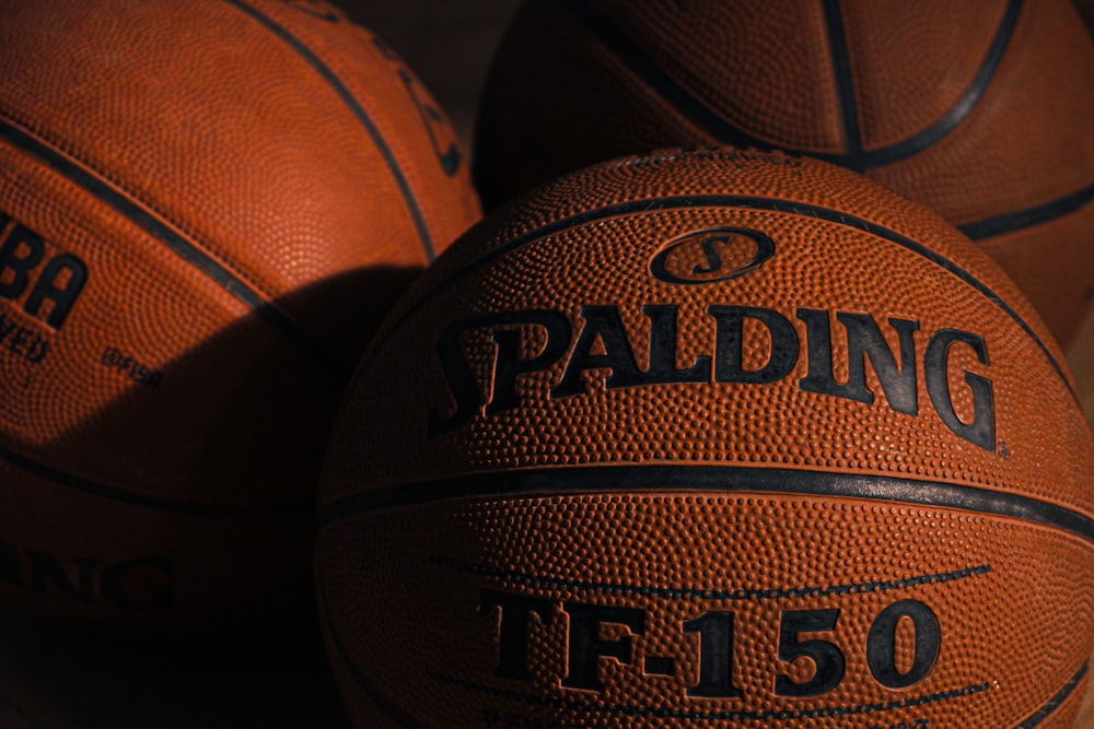 a close up of three basketballs on a table