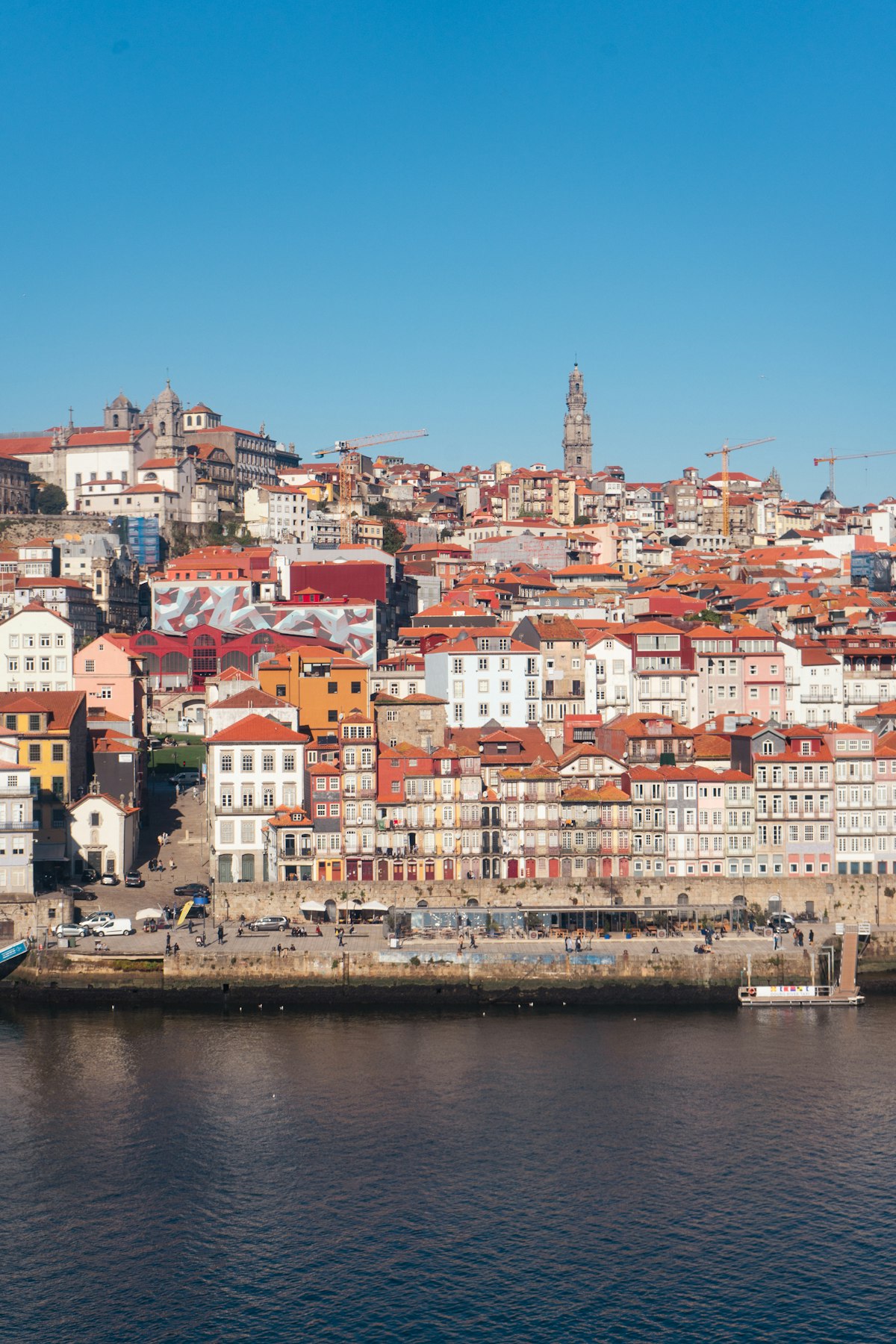 Porto October — city buildings rising above the Douro River in warm autumn light
